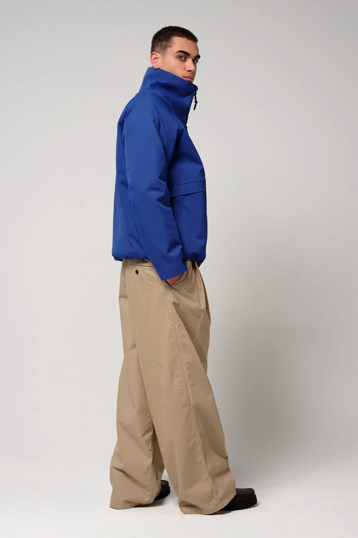 Model wearing Claud Sodalite Blue Coat, showcasing its stylish blue design and modern fit.