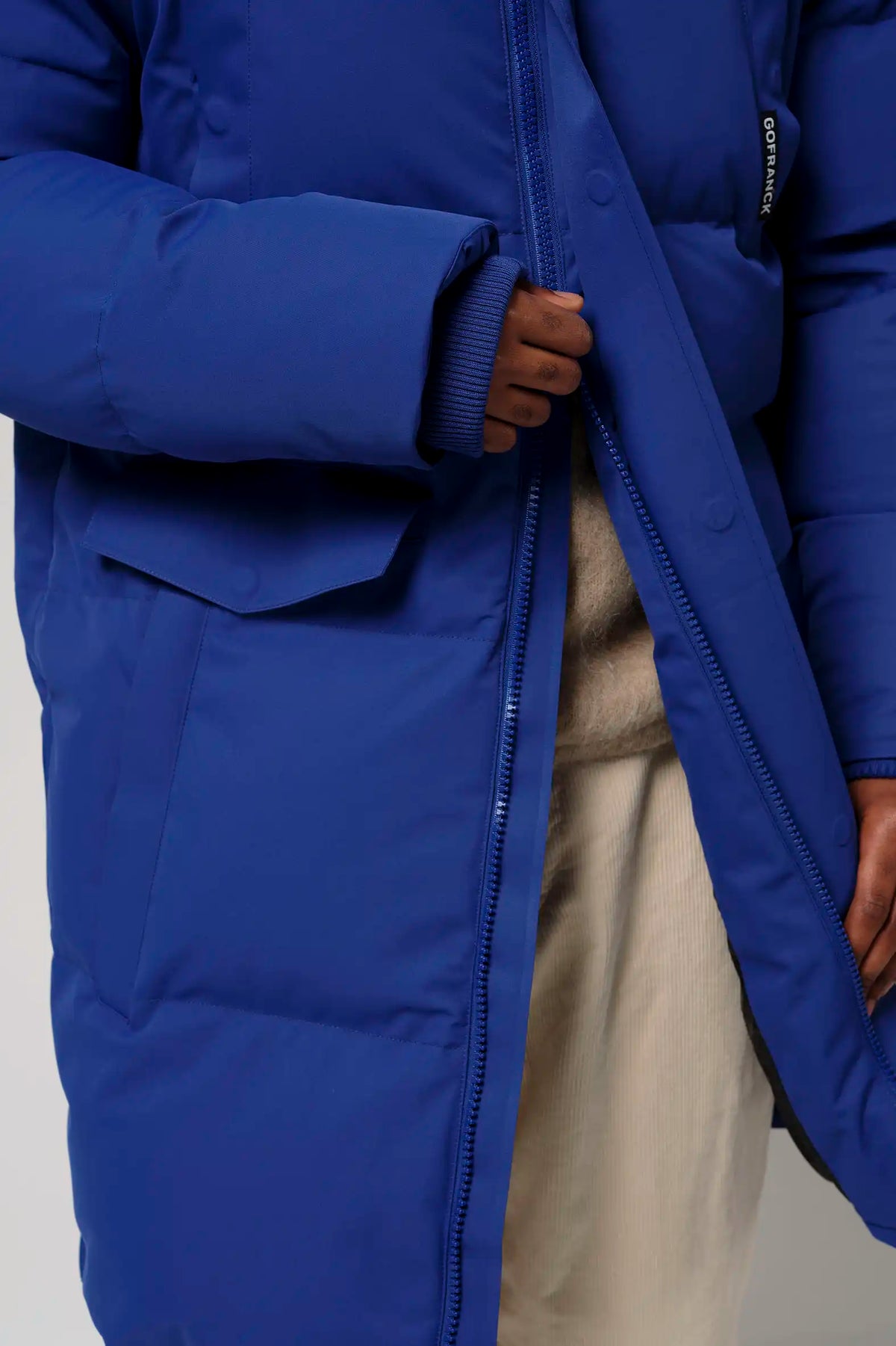 Climate Sodalite Blue Coat shown with thumb holes and two-way zipper in vibrant blue.