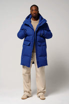 Model wearing Climate Sodalite Blue Coat, showcasing its waterproof, breathable, and windproof features.