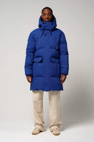 Model wearing Climate Sodalite Blue Coat, featuring waterproof and insulated design, ideal for winter conditions.