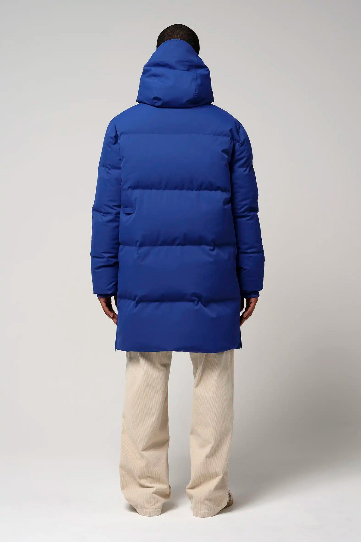 Climate Sodalite Blue Coat shown from the back, featuring a padded design and hood.