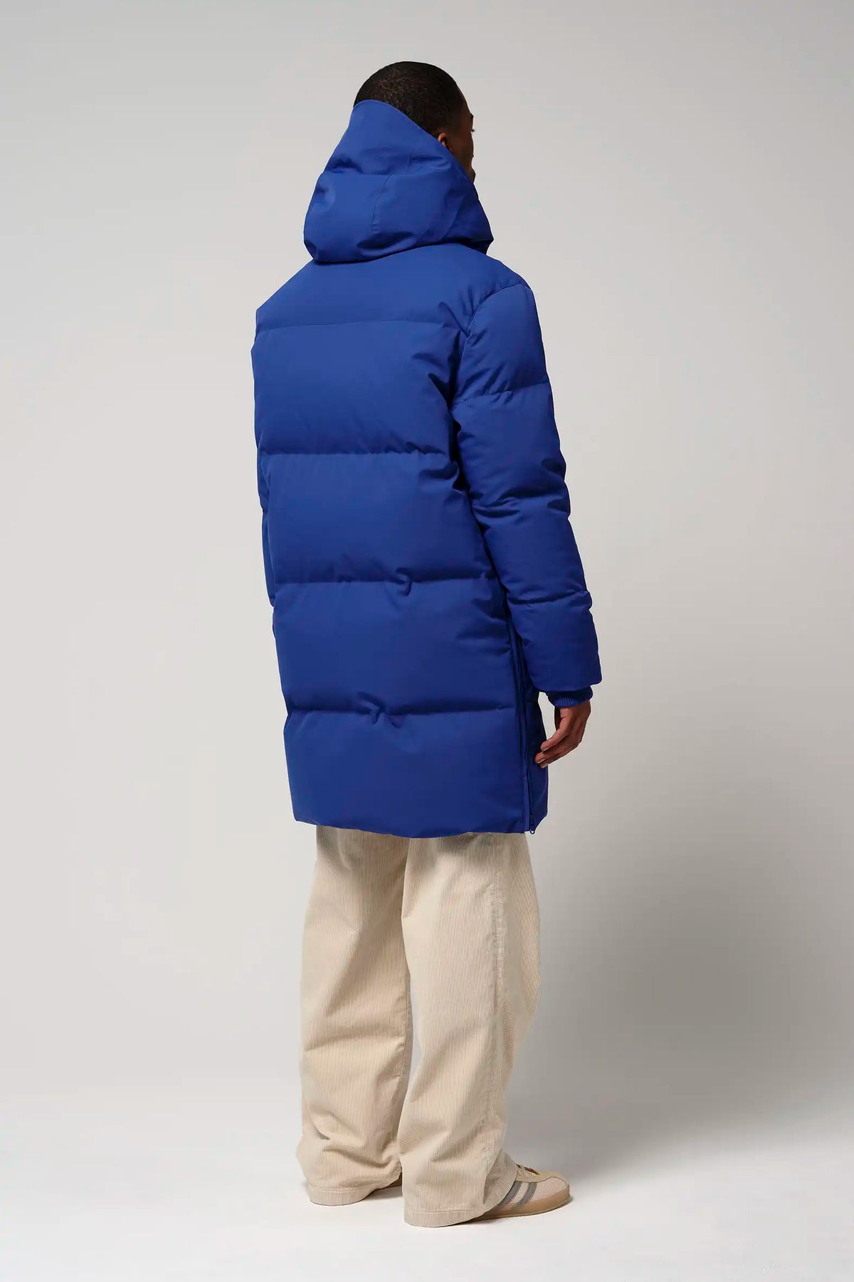 Model wearing the Climate Sodalite Blue Coat, showcasing its stylish blue design from the back.