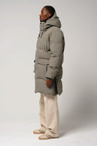 Climate Timber Wolf Grey Coat side view on model wearing beige pants and shoes, showcasing its modern design and functionality.