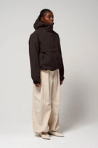 Guthrie Black Coffee Coat displayed on a model, showcasing its waterproof, breathable, and windproof features.
