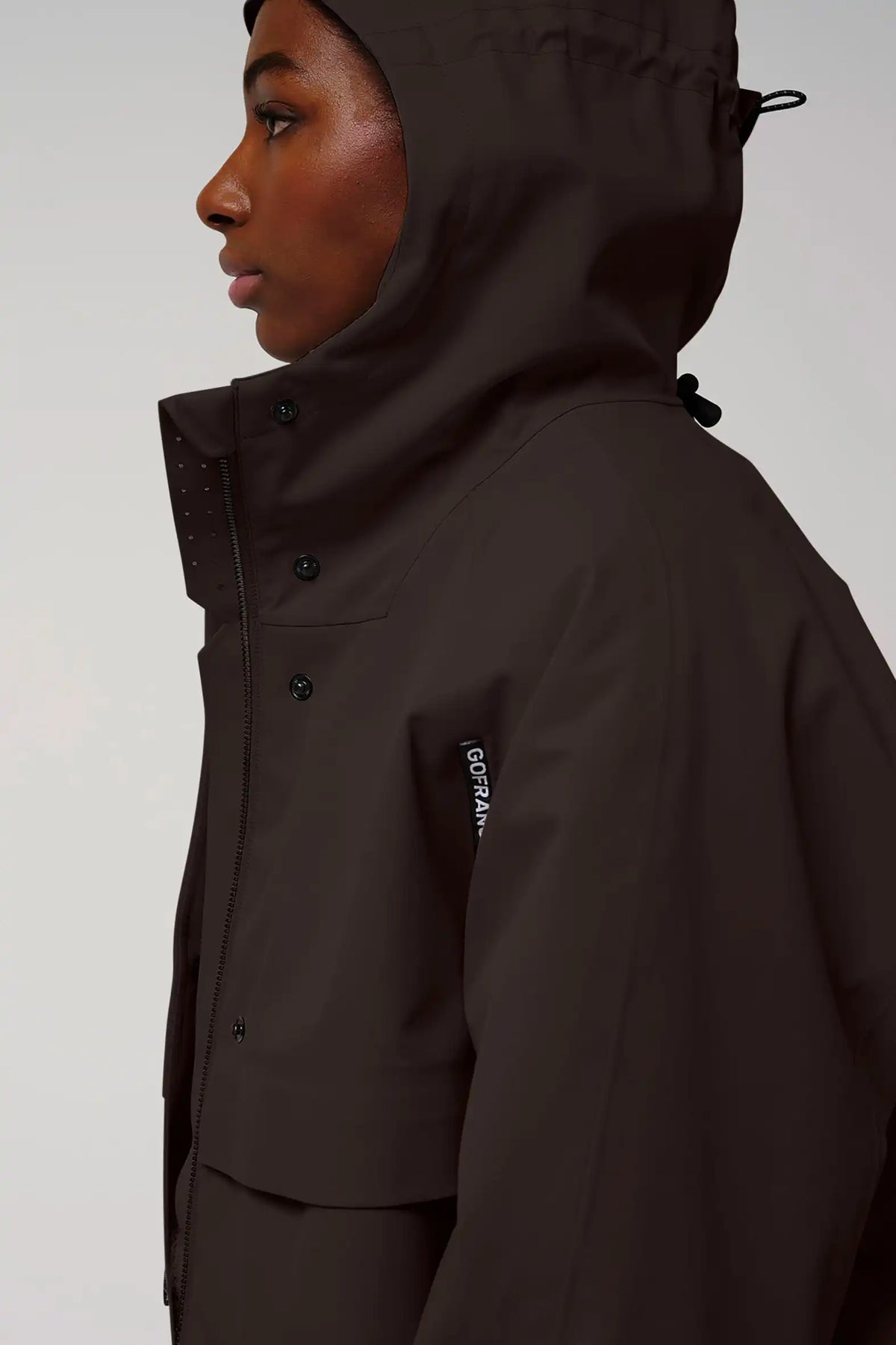 Guthrie Black Coffee Coat featuring adjustable hood and waterproof design for ultimate protection against heavy rain.