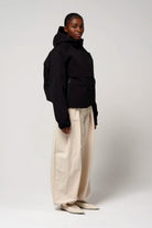 Guthrie Deep Black Coat worn by a model, showcasing its waterproof and windproof features.