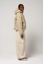 Guthrie Fields of Rye Beige Coat on model, showcasing waterproof, breathable features and adjustable hood.