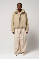 Guthrie Fields of Rye Beige Coat worn by a model, showcasing its waterproof and breathable features.