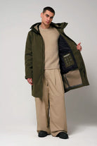 Raiden Dark Olive Green Parka worn by a model, showcasing its waterproof and breathable features.