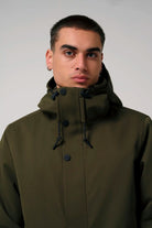 Raiden Dark Olive Green Parka worn by a model, showcasing its waterproof features and stylish design.