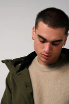 Raiden Dark Olive Green Parka showcased on model, highlighting style and warmth for chilly weather.