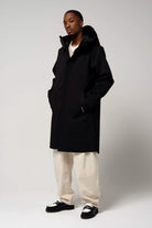 Raiden Deep Black Parka on model, showcasing waterproof, breathable, and windproof features.