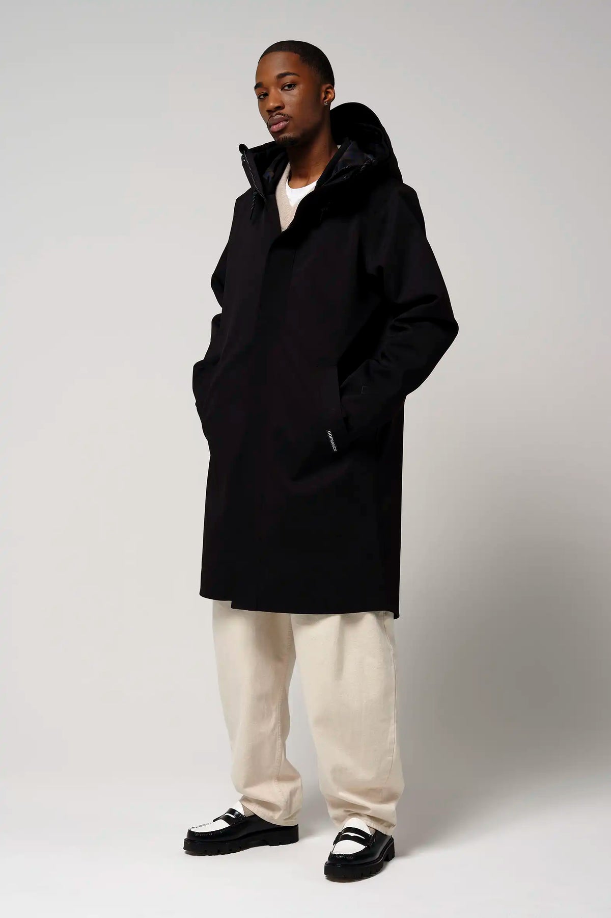Raiden Deep Black Parka on model, showcasing waterproof, breathable, and windproof features.
