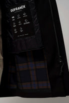 Interior view of Raiden Deep Black Parka showing waterproof insulation and plaid lining.