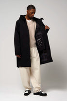 Model wearing Raiden Deep Black Parka, showcasing its waterproof features and adjustable hood.