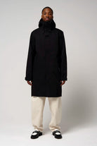 Model wearing Raiden Deep Black Parka, featuring breathable, waterproof design, with adjustable hood and two-way zipper.