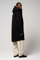 Raiden Deep Black Parka, stylish waterproof black parka with adjustable hood and two-way zipper, model wearing from behind.