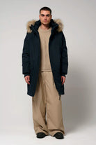 Stratus Sky Captain Blue Parka worn by a model, showcasing waterproof and breathable features, with faux fur trim.
