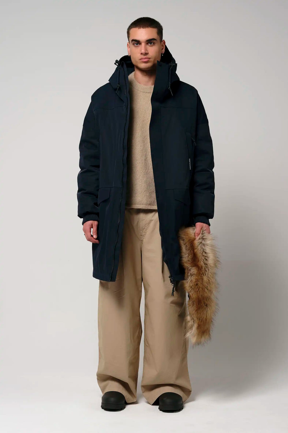 Stratus Sky Captain Blue Parka model wearing waterproof winter coat with removable faux fur trim and adjustable hood.