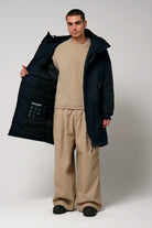 Stratus Sky Captain Blue Parka displayed by a model, showcasing its interior features and windproof design.