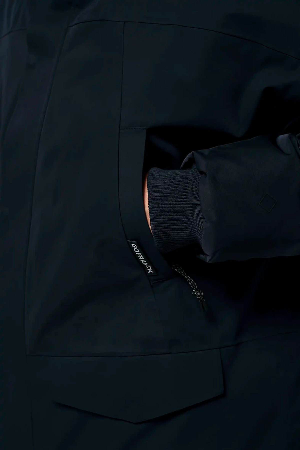 Close-up of Stratus Sky Captain Blue Parka pocket and sleeve detail showcasing waterproof material and design features.
