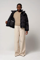 Talon Blue Tartan Check Coat worn by model, highlighting its stylish design and adjustable features.