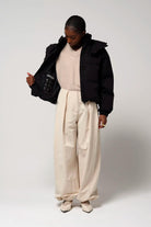 Model wearing Talon Deep Black Coat, showcasing its stylish design and comfortable fit.