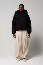 Model wearing the Talon Deep Black Coat with breathable and waterproof features.