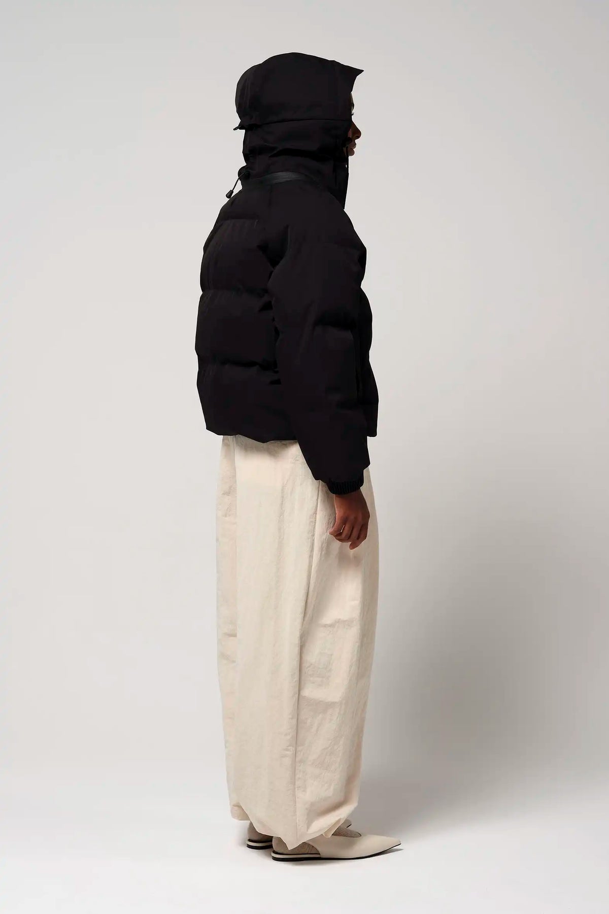 Talon Deep Black Coat worn by a model, showcasing the adjustable hood and sleek design.