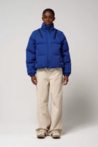 Person wearing a Talon Sodalite Blue Coat, featuring a stylish design and high-performance fabric.