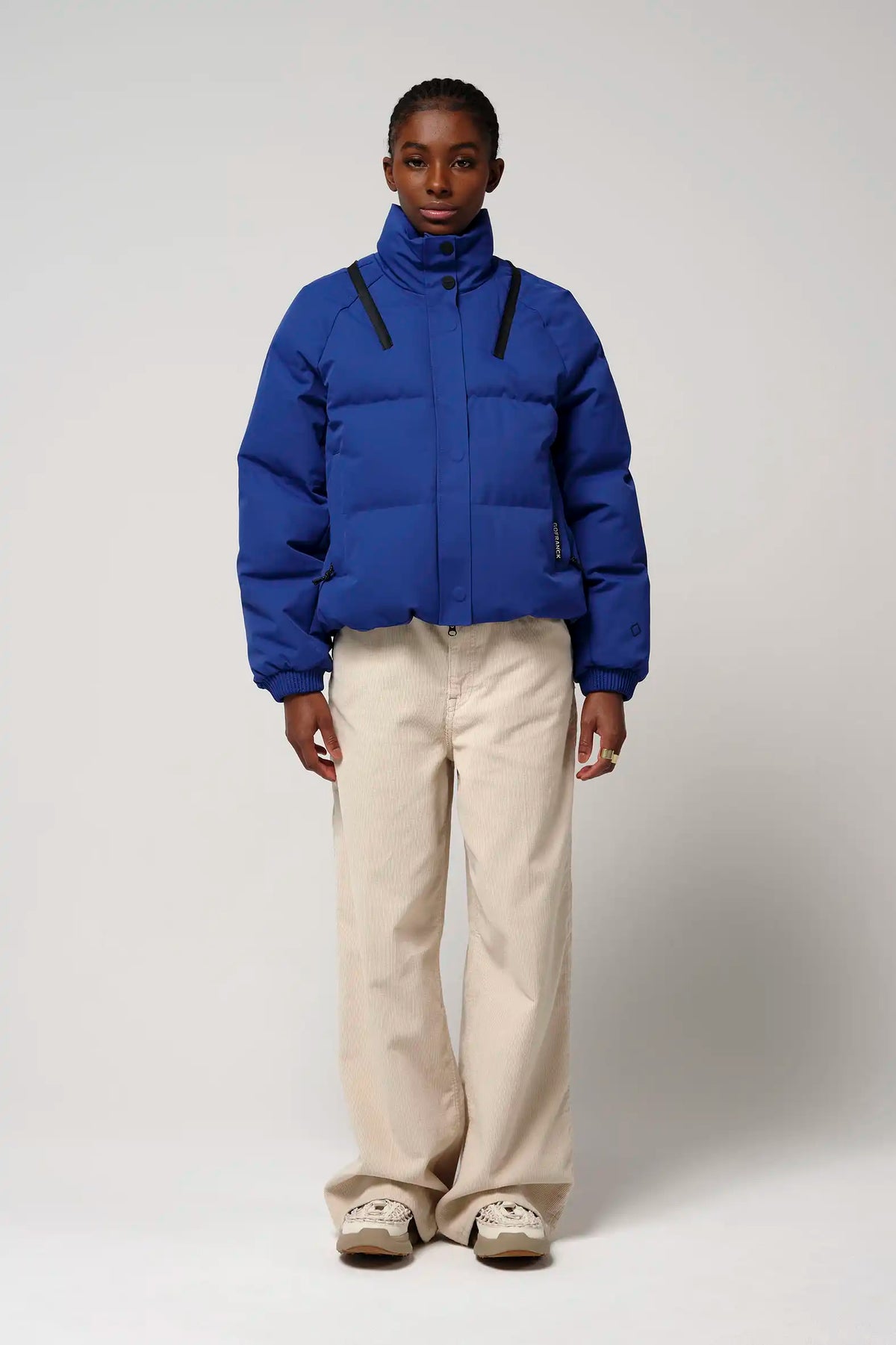 Person wearing a Talon Sodalite Blue Coat, featuring a stylish design and high-performance fabric.