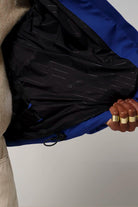 Interior view of Talon Sodalite Blue Coat showcasing lined black material and adjustable features.