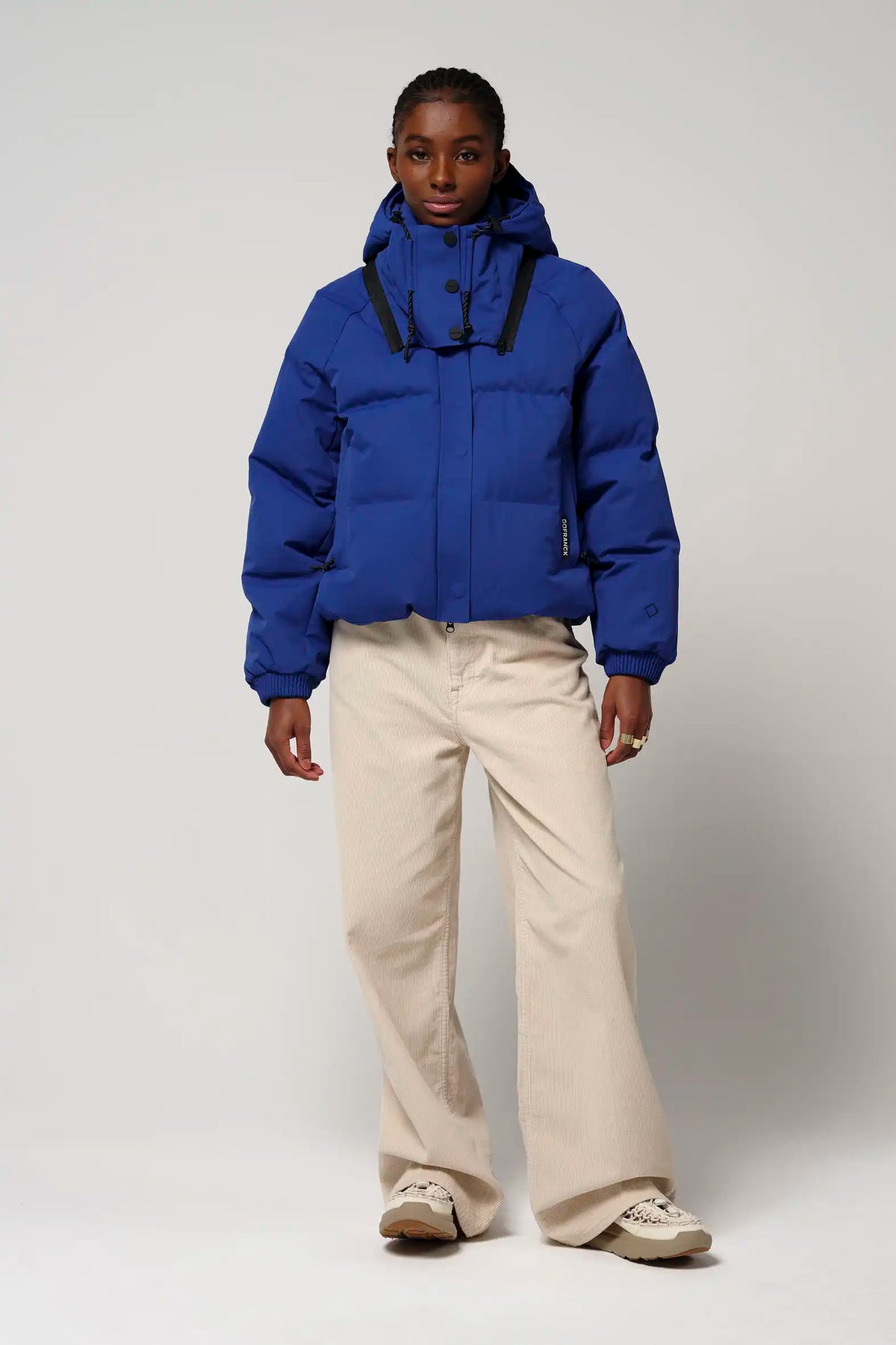 Talon Sodalite Blue Coat worn by a model, showcasing its waterproof and stylish design.
