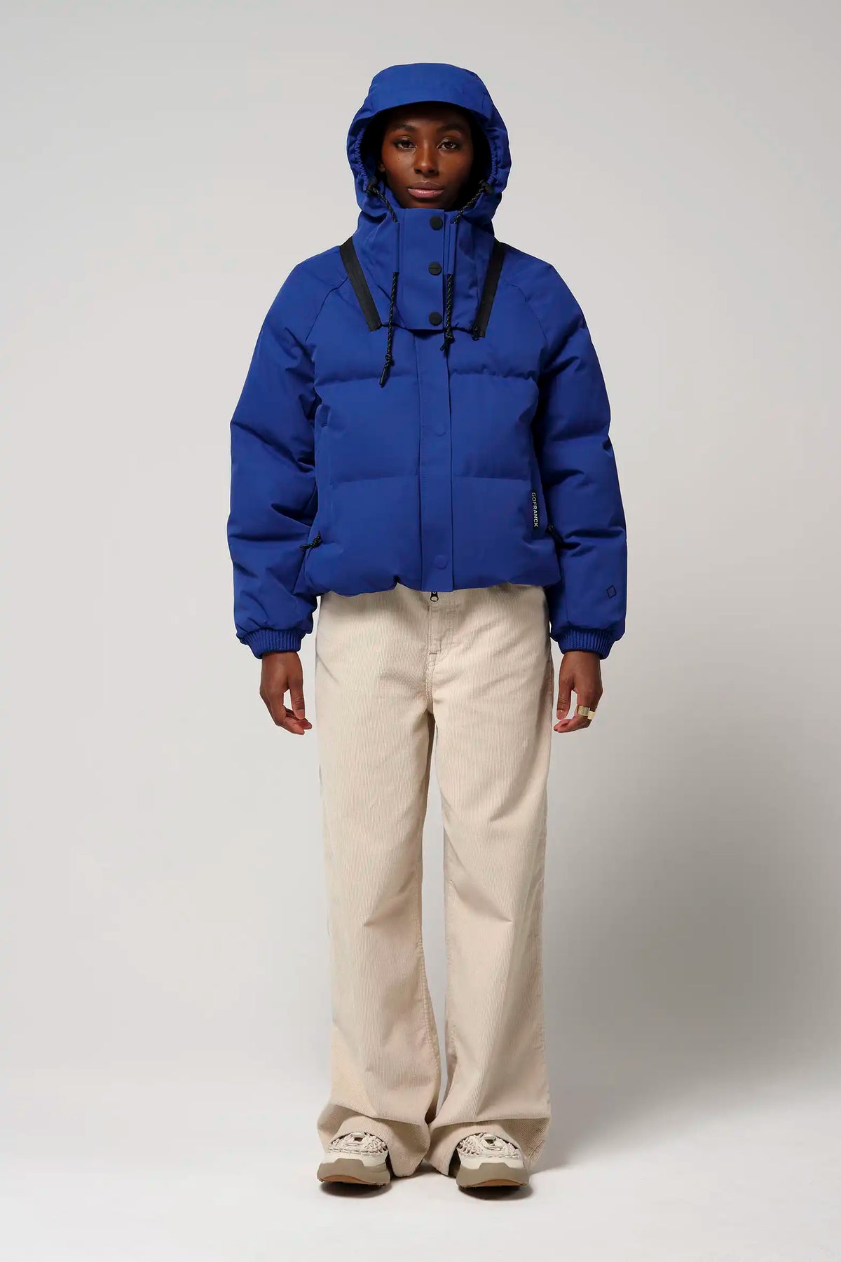 Talon Sodalite Blue Coat worn by a model, showcasing its waterproof and breathable design.