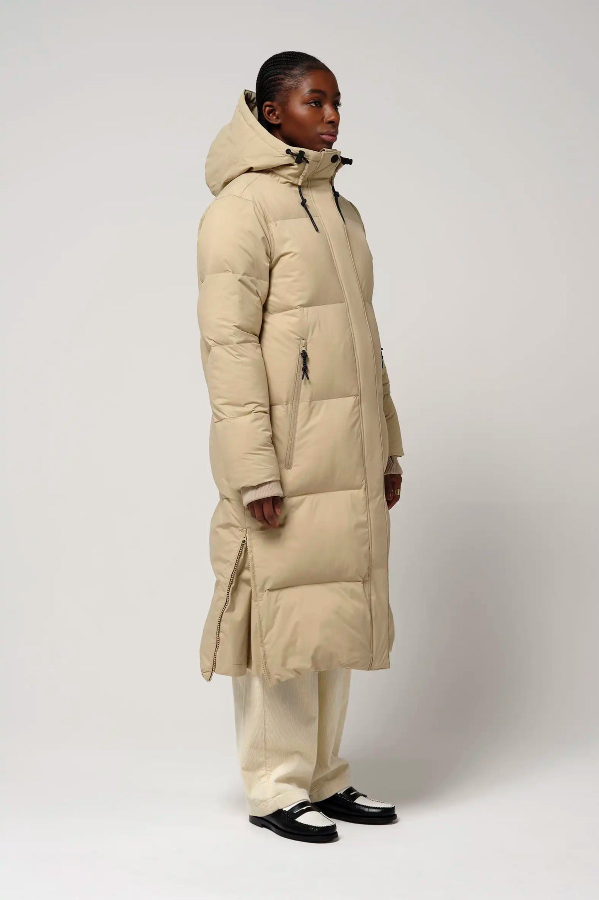 Tsunami Fields of Rye Beige Coat displayed on a model, highlighting its lightweight puffer design and stylish fit.