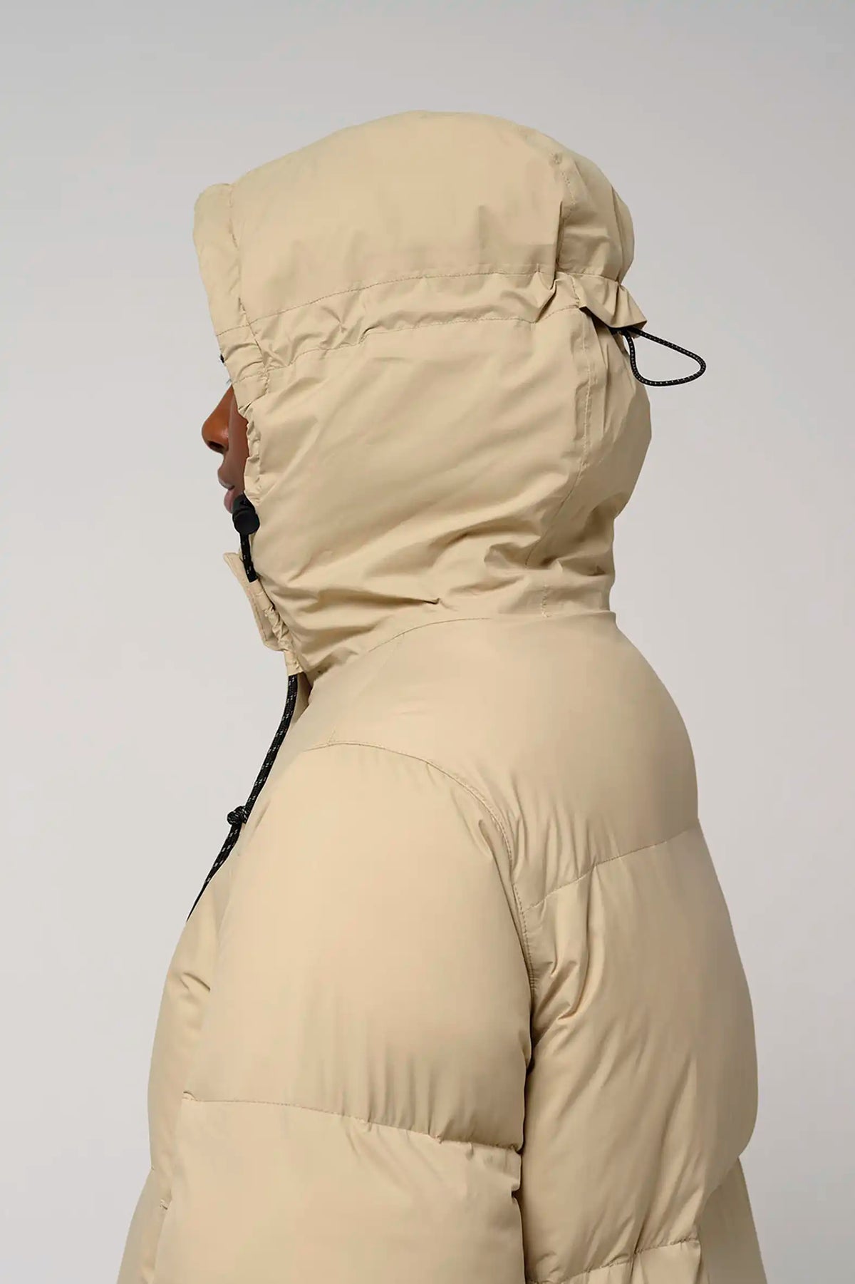 Tsunami Fields of Rye Beige Coat shown from the side, featuring a hood and puffer design.