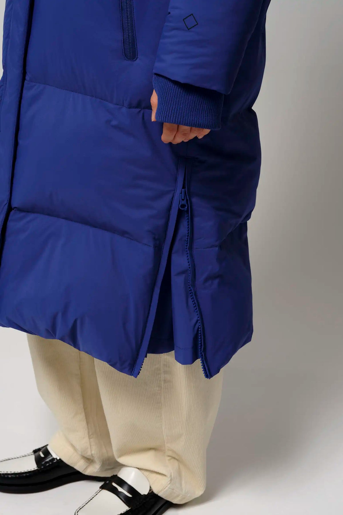 Tsunami Sodalite Blue Coat showcasing the side zipper and thumb hole cuffs for added comfort.