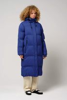 Tsunami Sodalite Blue Coat lightweight waterproof puffer coat worn by model with curly hair.