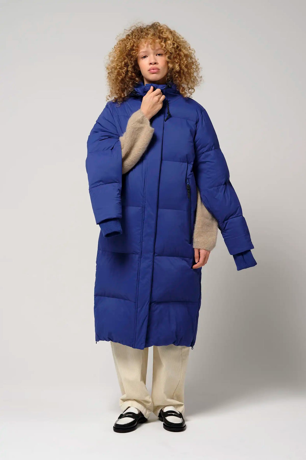 Tsunami Sodalite Blue Coat model wearing puffer coat, showcasing lightweight, waterproof, and windproof features.