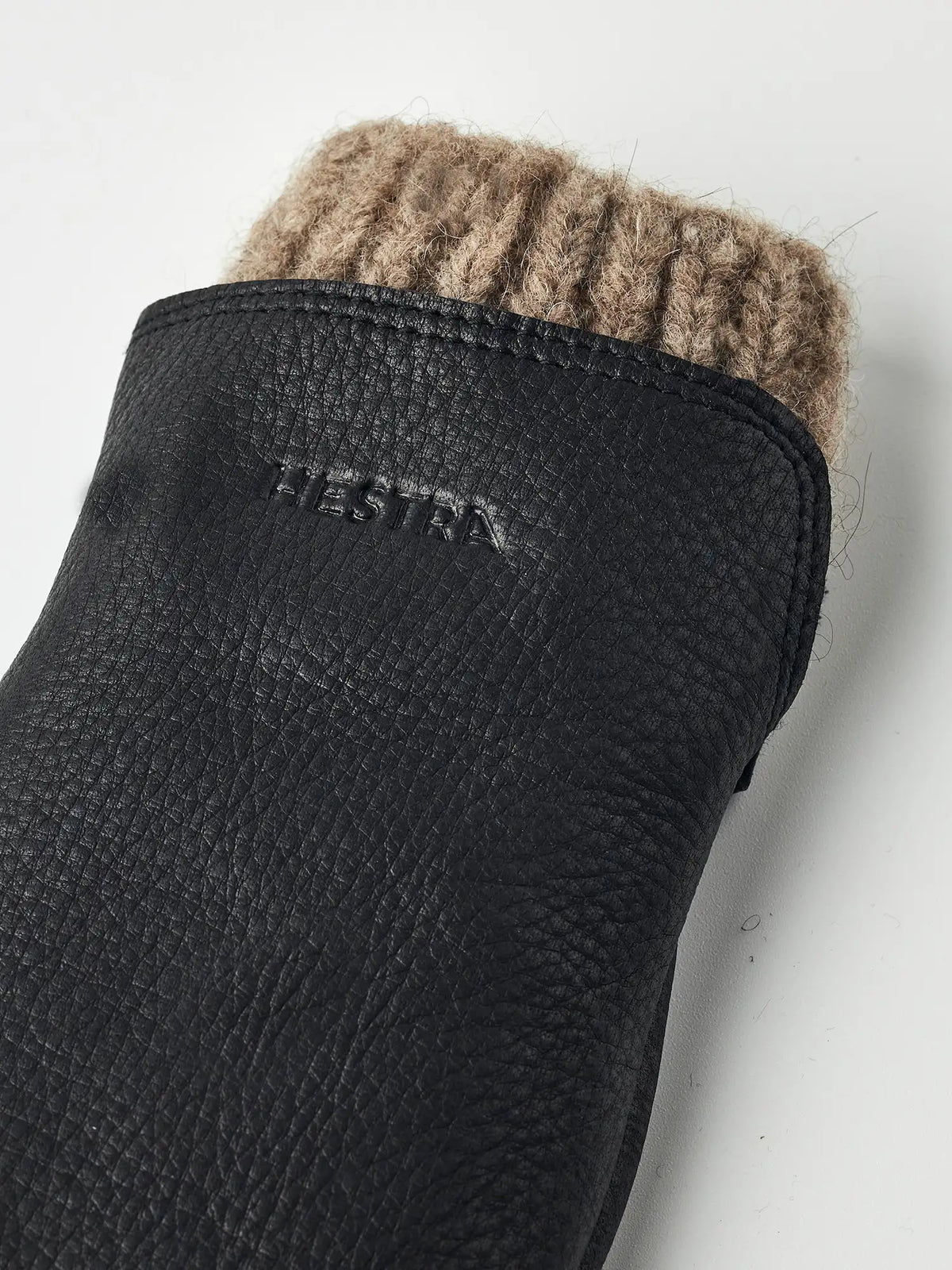 Hestra Tiril Black Gloves close-up showing soft wool lining and deerskin nappa leather texture.
