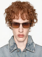 Ryder Black Matte Sunglasses worn by a model with curly hair in a denim jacket.