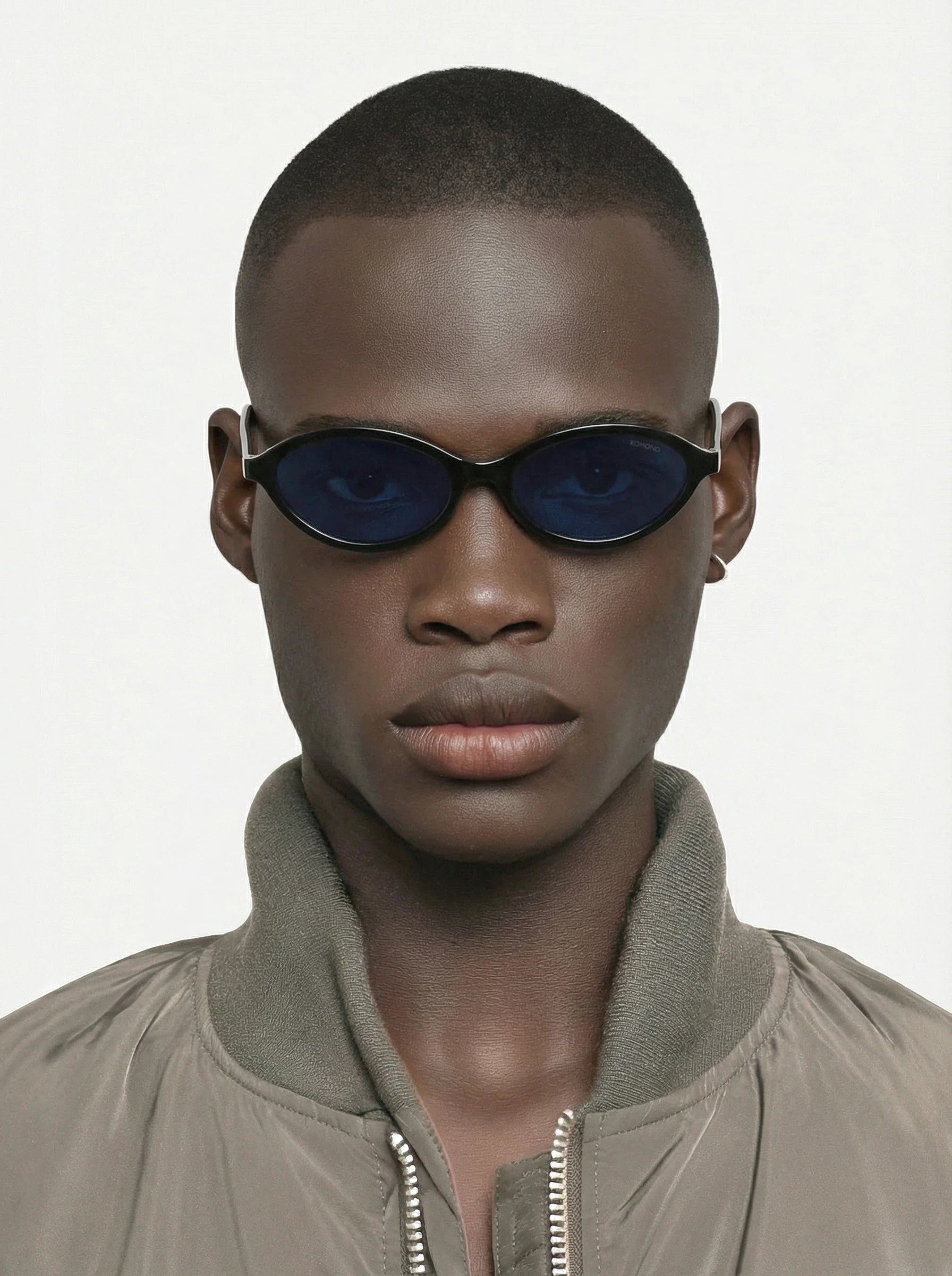 Doris Black Sunglasses worn by a model, featuring blue lenses and stylish design, showcasing unisex UV 400 protection.
