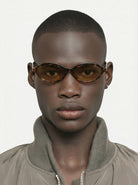 Doris Havana Amber Sunglasses worn by a model, featuring a unisex design and UV 400 protection.
