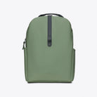 Clip Front Backpack Well Backpack in green with a sleek design and side pockets.