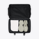 Texel Cabin Bag Small Blue Dusk Suitcase opened with shoes and towel inside.