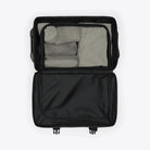 Texel Cabin Bag Small Blue Dusk Suitcase open showing organized packing with mesh pockets and compartments.
