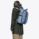 Texel Moulded Backpack Blue Dusk Backpack worn by a model, showcasing its waterproof design and modern style.