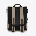 Back view of the Trail Mountaineer Rolltop Beige Backpack featuring padded shoulder straps and breathable mesh.