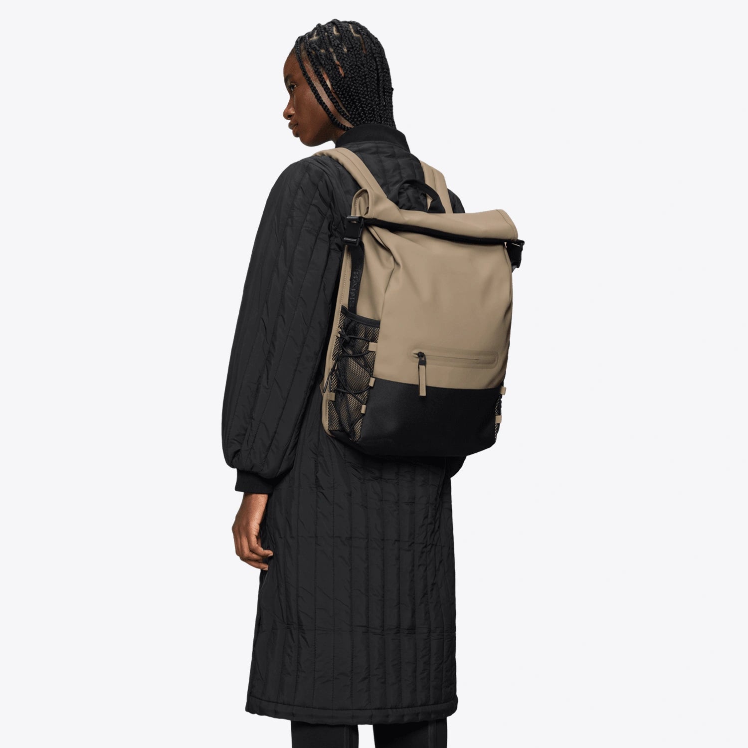 Trail Mountaineer Rolltop Beige Backpack worn by a model, showcasing its stylish design and functionality.