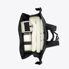 Interior view of the Trail Mountaineer Rolltop Beige Backpack with packed items, showcasing its spacious design and organization.